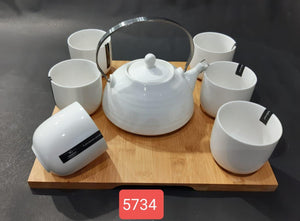 Kettle with cups on wooden tray